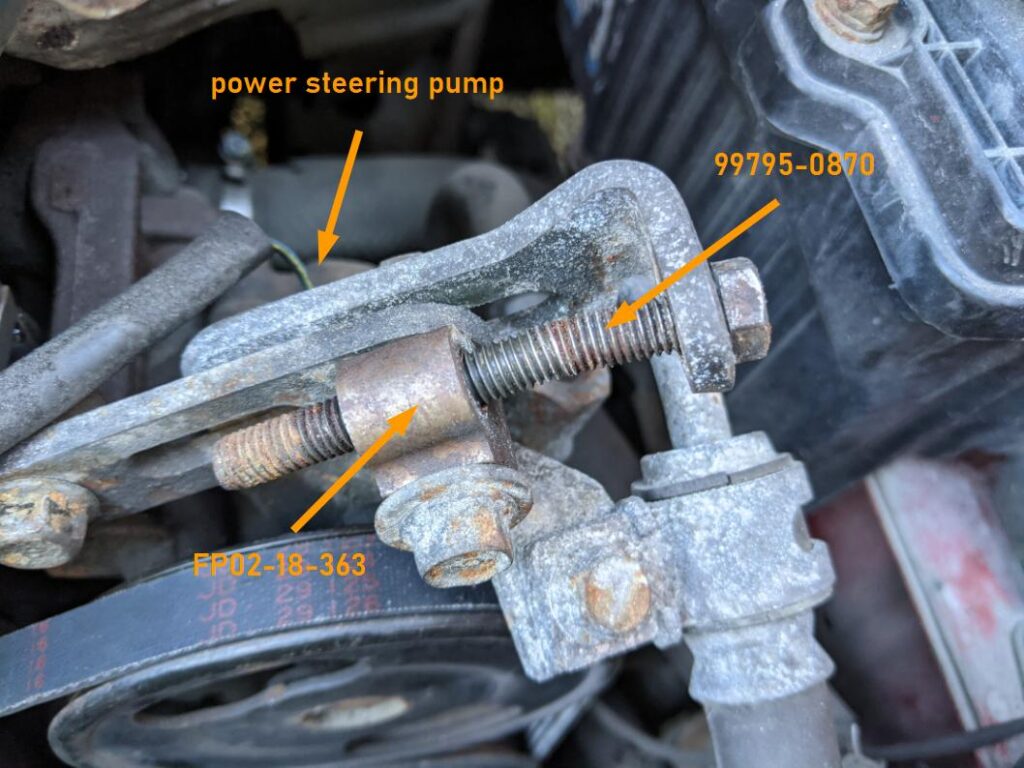 Miata NA power steering pump adjustment bolt (bent) and spacer